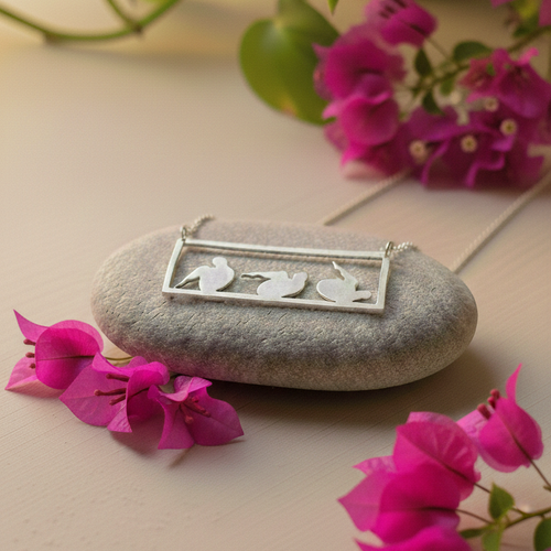 Rolling like a ball sterling silver pendant set on a stone for display