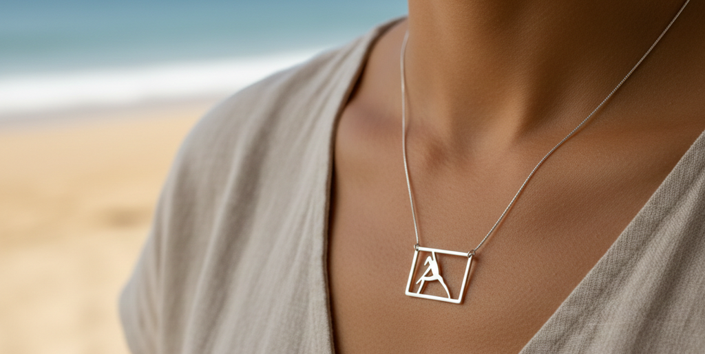 Pilates Side stretch reaching out necklace - sterling silver on a woman at the beach.